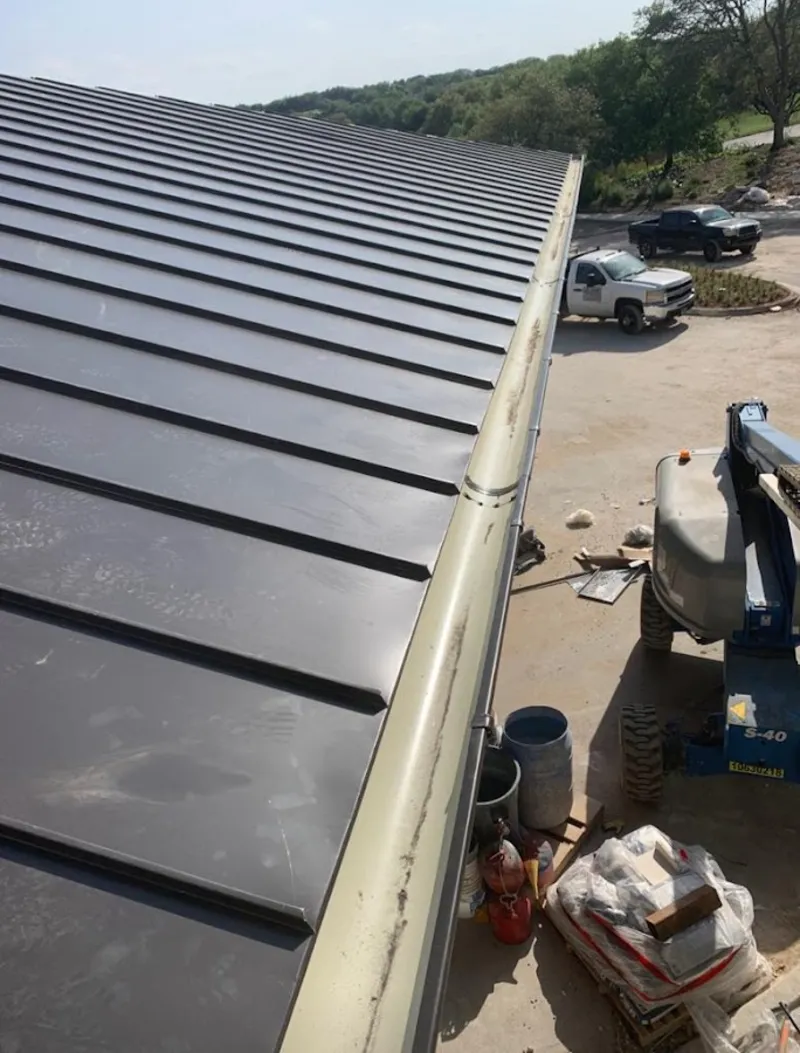 Standing seam panel and gutter detail on a metal roofing jobsite in Circleville